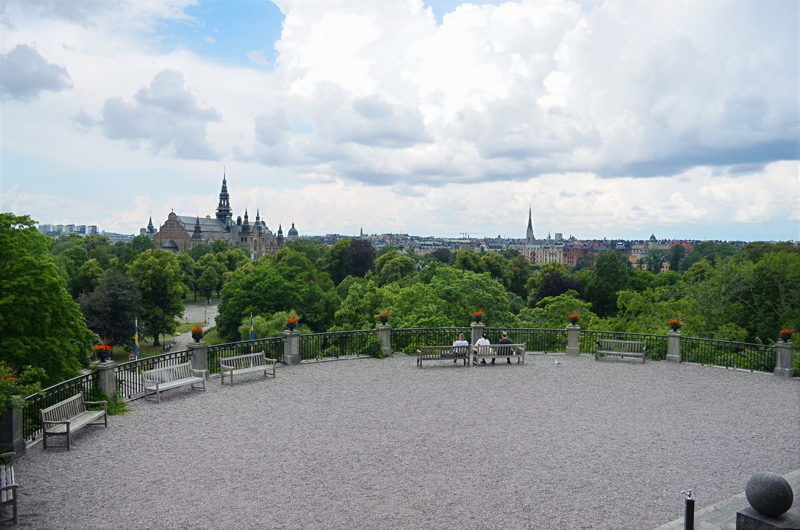 22 - Scenic view of the historic Nordic Museum in Stockholm, Sweden, with its distinctive towering spire visible across lush parkland